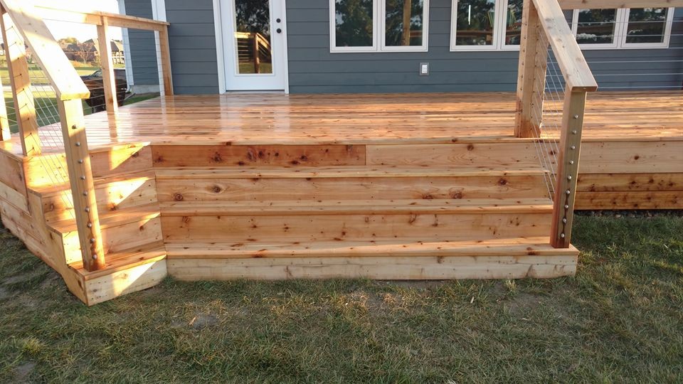 Example of a large mountain style deck design with a pergola