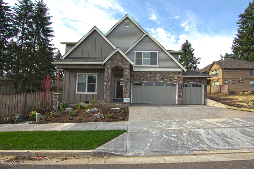 Photo of a mid-sized transitional two-storey grey exterior in Portland with concrete fiberboard siding and a gable roof.