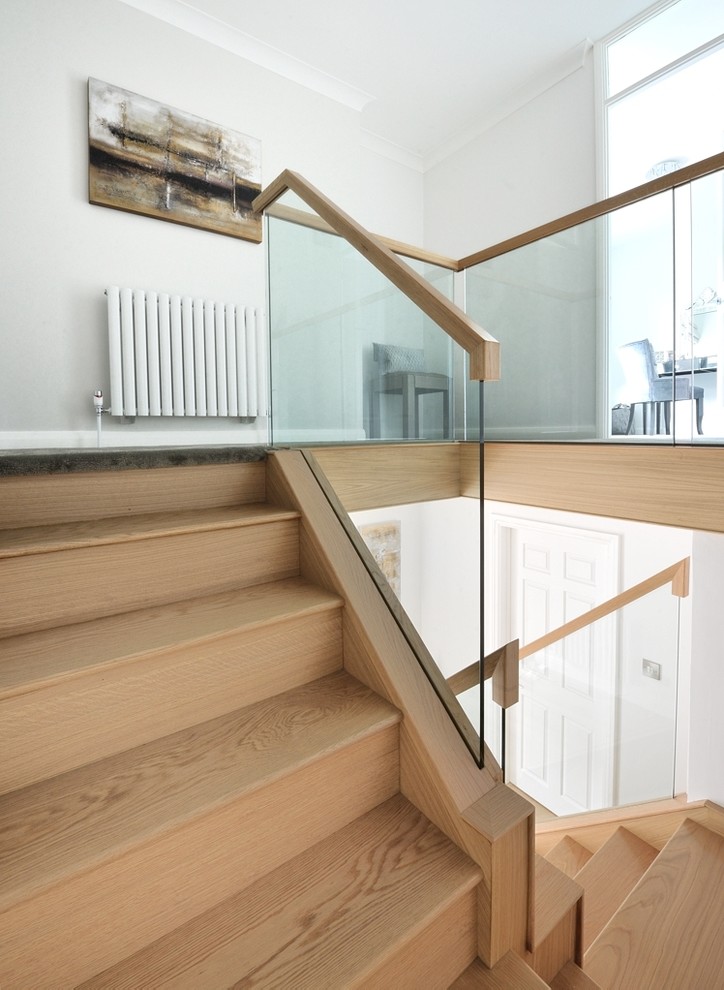 Inspiration for a mid-sized traditional wood curved staircase in Other with wood railing and wood risers.