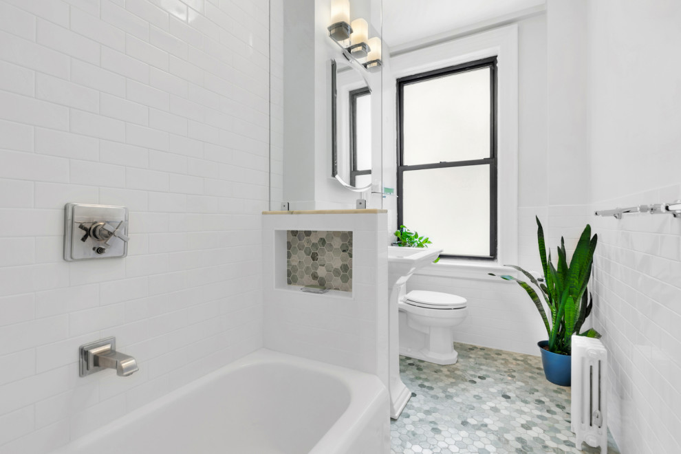 Design ideas for a mid-sized mediterranean master bathroom in New York with open cabinets, white cabinets, a claw-foot tub, an alcove shower, a one-piece toilet, white tile, ceramic tile, white walls, marble floors, a pedestal sink, solid surface benchtops, green floor, a shower curtain, white benchtops, a niche, a single vanity and a freestanding vanity.