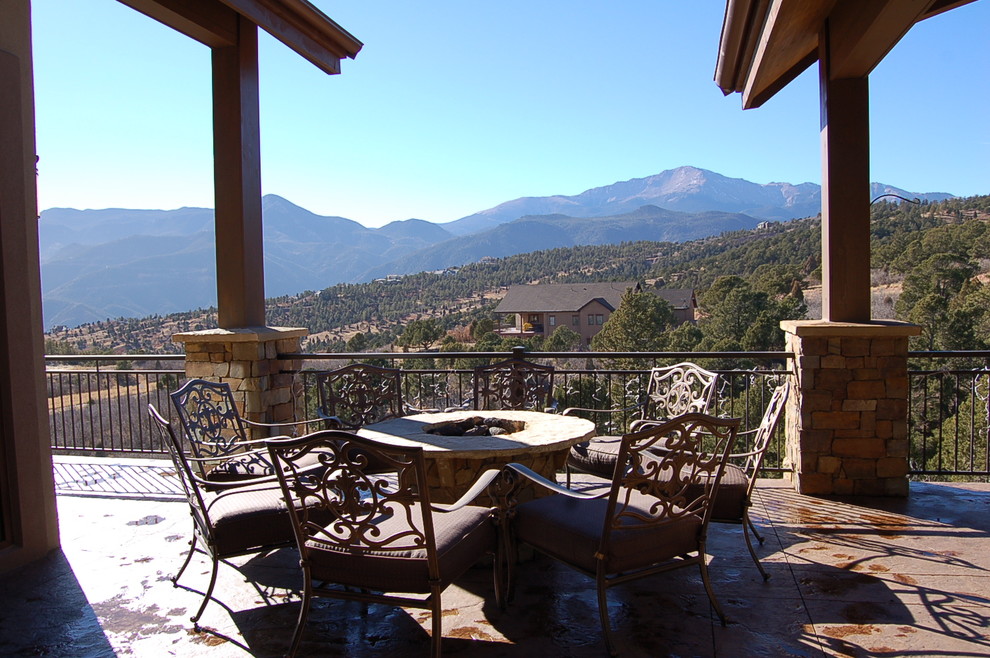 Deck - large rustic side yard deck idea in Denver with a roof extension and a fire pit