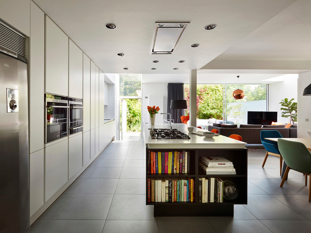 Inspiration for a large contemporary galley open plan kitchen in Manchester with flat-panel cabinets, white cabinets, stainless steel appliances and with island.