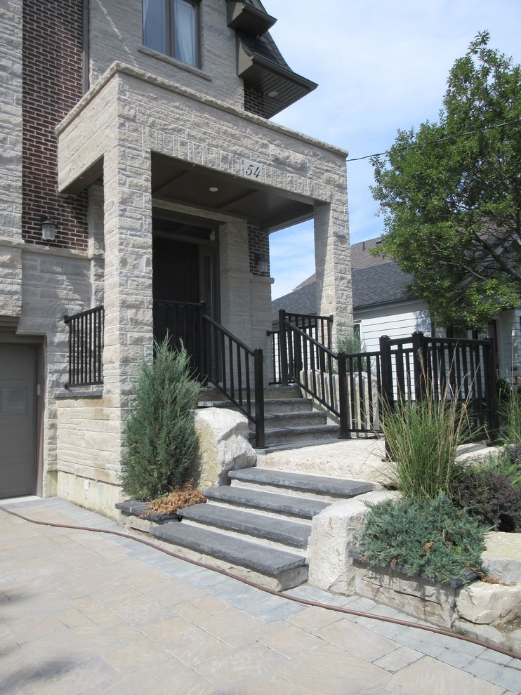Example of a small transitional granite floor and white floor front door design in Toronto with beige walls and a black front door