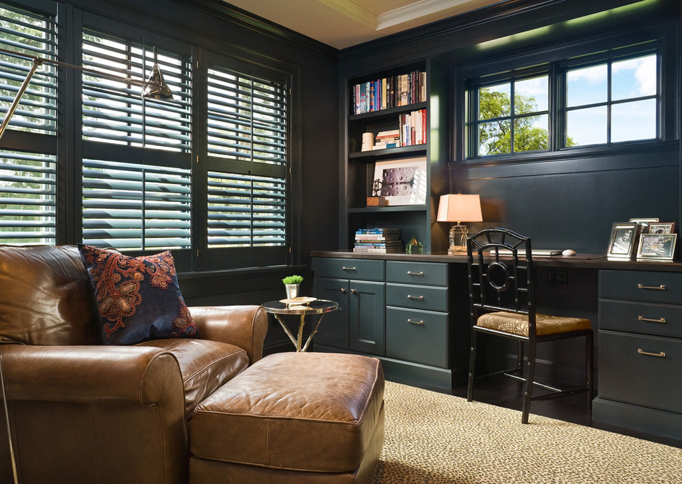 This is an example of a traditional home office in Seattle with a built-in desk.