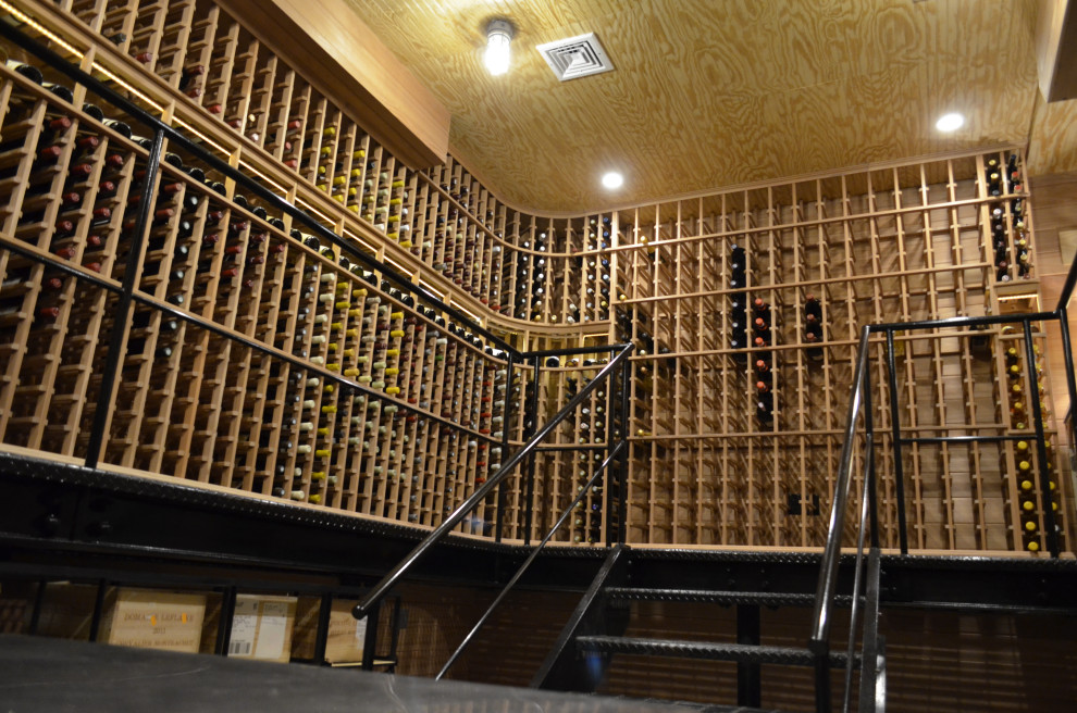 Expansive arts and crafts wine cellar in New York with storage racks.