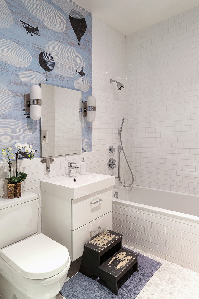 Inspiration for a transitional bathroom in New York with flat-panel cabinets, white cabinets, an alcove tub, a shower/bathtub combo, a two-piece toilet, white tile, subway tile, mosaic tile floors and a console sink.