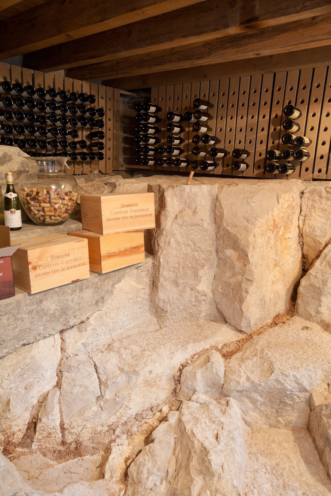 Mid-sized mediterranean wine cellar in Dijon with storage racks.