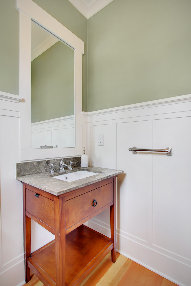Traditional powder room in Seattle with an undermount sink, flat-panel cabinets, medium wood cabinets and grey benchtops.