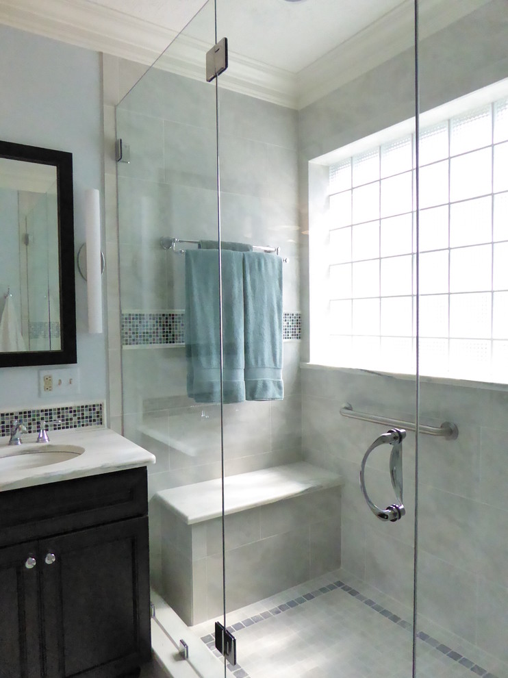 Mid-sized transitional master blue tile porcelain tile double shower photo in Indianapolis with an undermount sink, beaded inset cabinets, dark wood cabinets, marble countertops, a two-piece toilet and blue walls