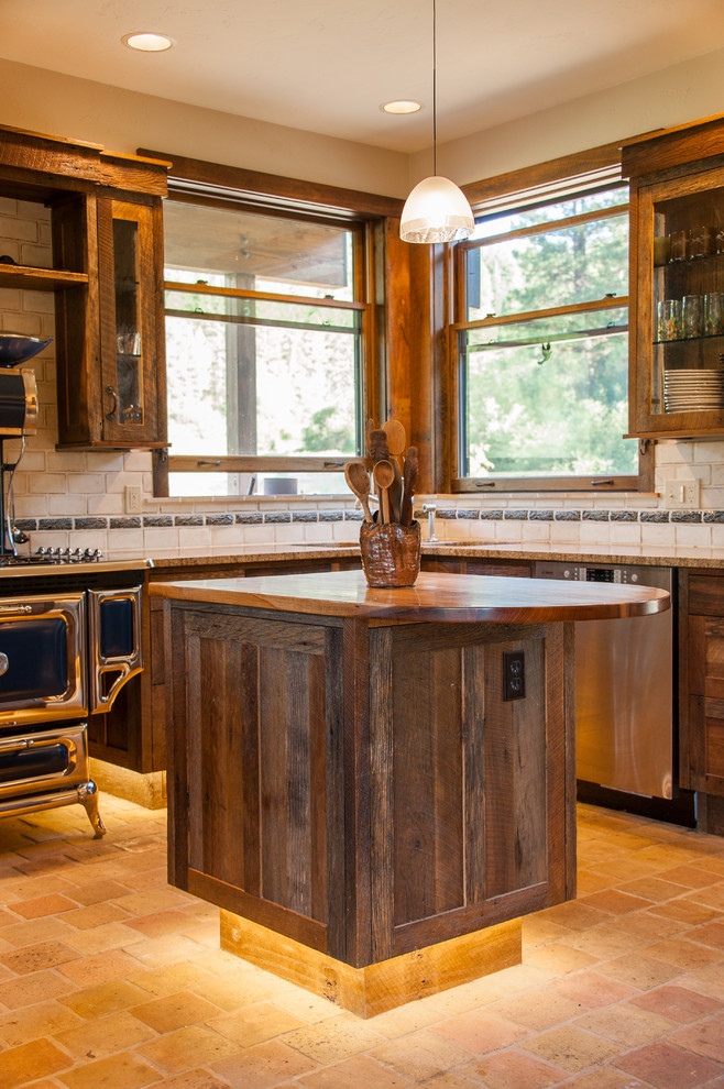 Large mountain style u-shaped cement tile floor and beige floor open concept kitchen photo in Seattle with recessed-panel cabinets, granite countertops, beige backsplash, ceramic backsplash, stainless steel appliances, an island, an undermount sink and dark wood cabinets