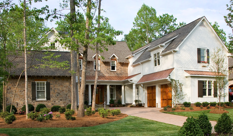 Photo of a large traditional two-storey white exterior in Raleigh with mixed siding.