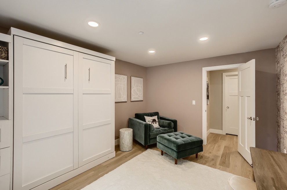 Photo of a large mediterranean look-out basement in Denver with grey walls, laminate floors and grey floor.