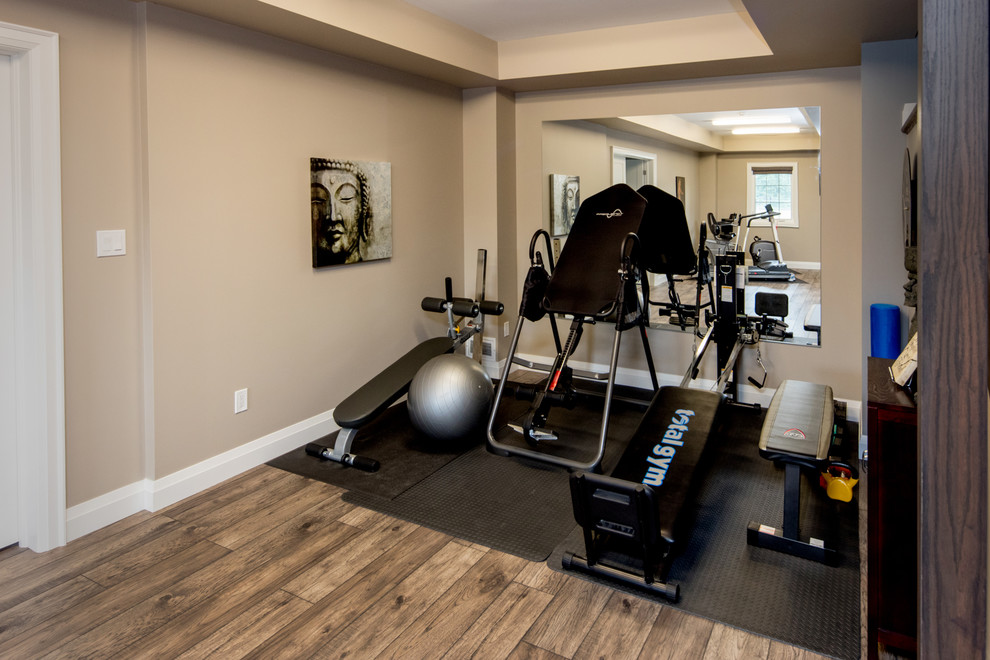 Mid-sized transitional multipurpose gym in Toronto with beige walls, medium hardwood floors and brown floor.