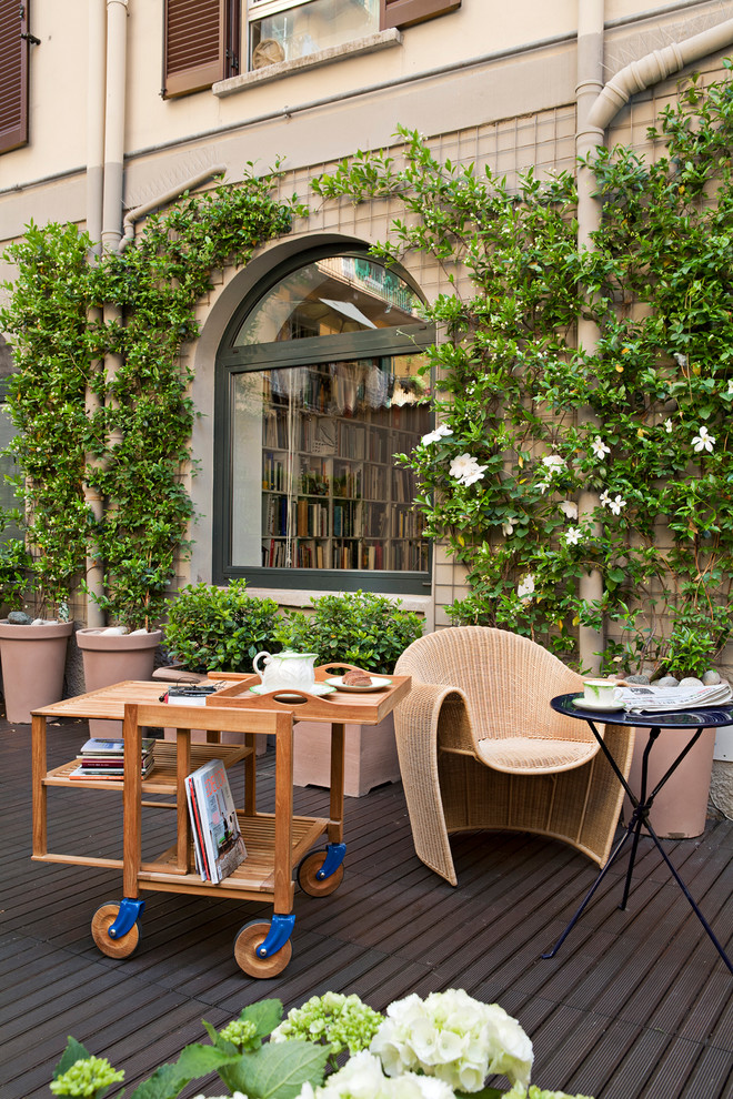 Traditional side yard patio in Florence with no cover, decking and a vertical garden.