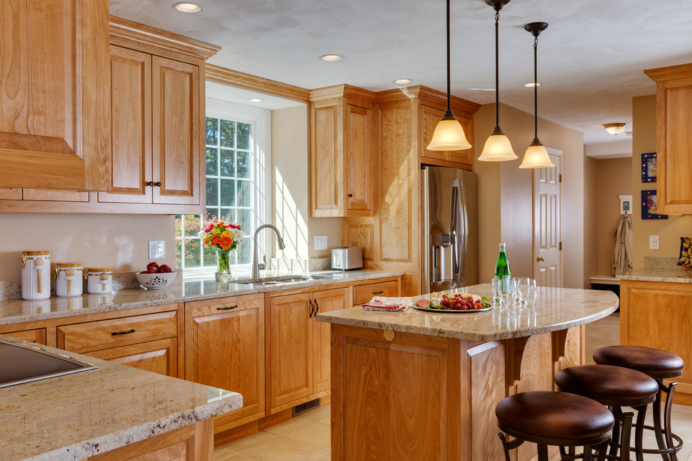 Inspiration for a large transitional l-shaped porcelain tile open concept kitchen remodel in Boston with an undermount sink, medium tone wood cabinets, granite countertops, stainless steel appliances and two islands
