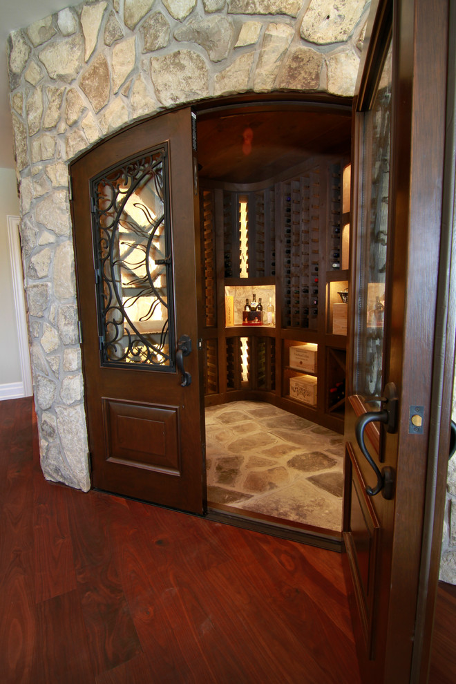 Design ideas for a mid-sized country wine cellar in Toronto with slate floors and storage racks.