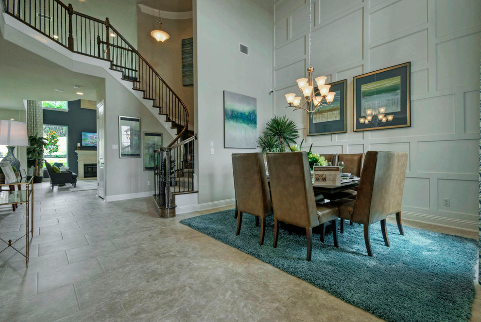 Design ideas for a large transitional open plan dining in Austin with white walls, porcelain floors and no fireplace.