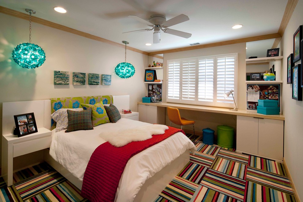 This is an example of a contemporary kids' room for girls in Orange County with beige walls and carpet.