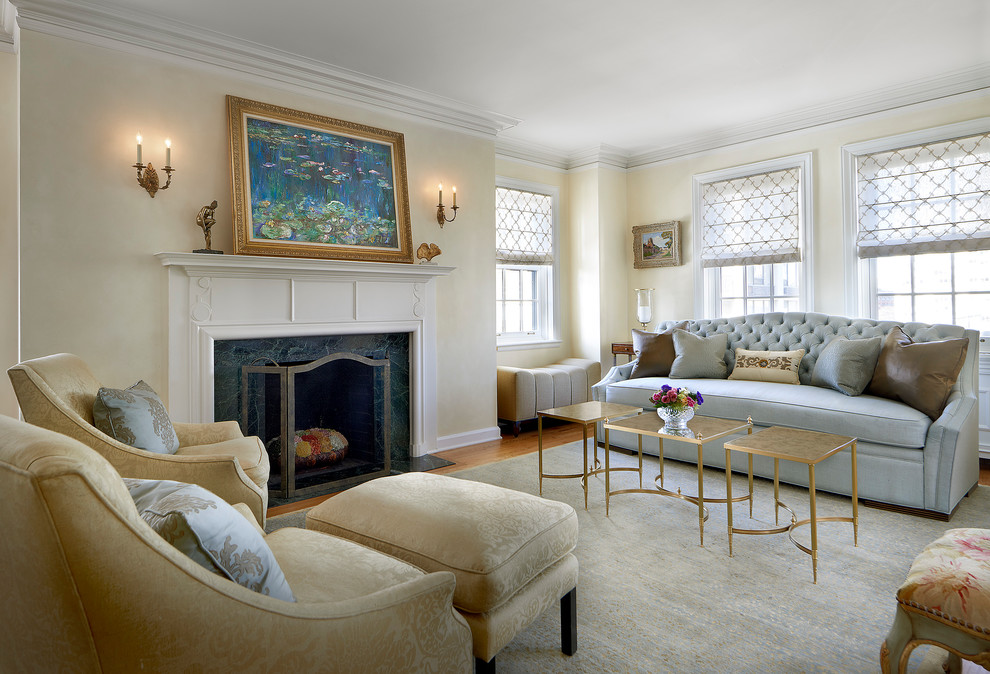 This is an example of a mid-sized traditional living room in Chicago with yellow walls, a standard fireplace and a stone fireplace surround.