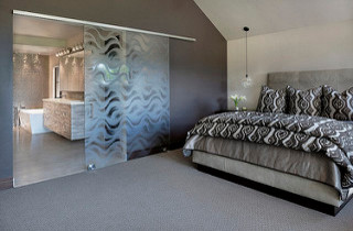 Large contemporary master bedroom in Denver with grey walls, carpet and no fireplace.