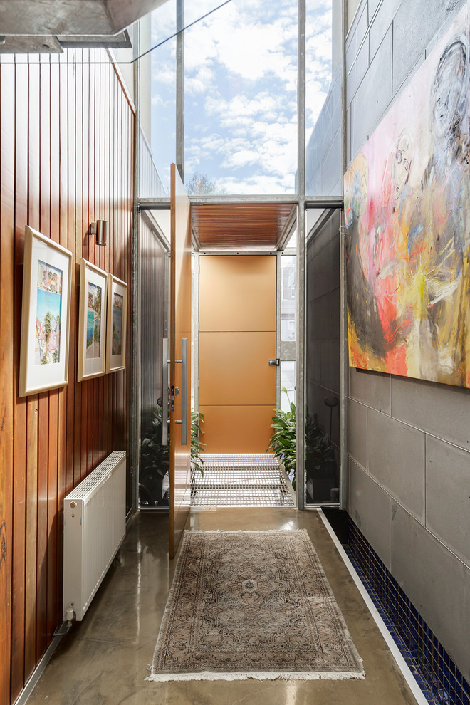 Photo of a mid-sized contemporary hallway in Other with concrete floors and grey floor.