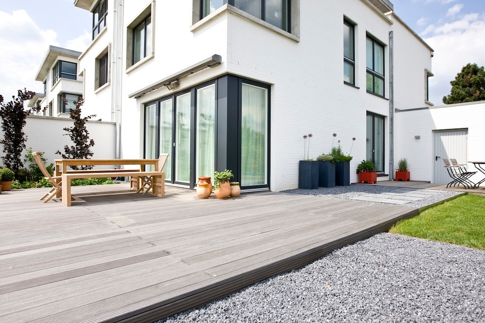 This is an example of a large contemporary backyard deck in Dusseldorf with a container garden.