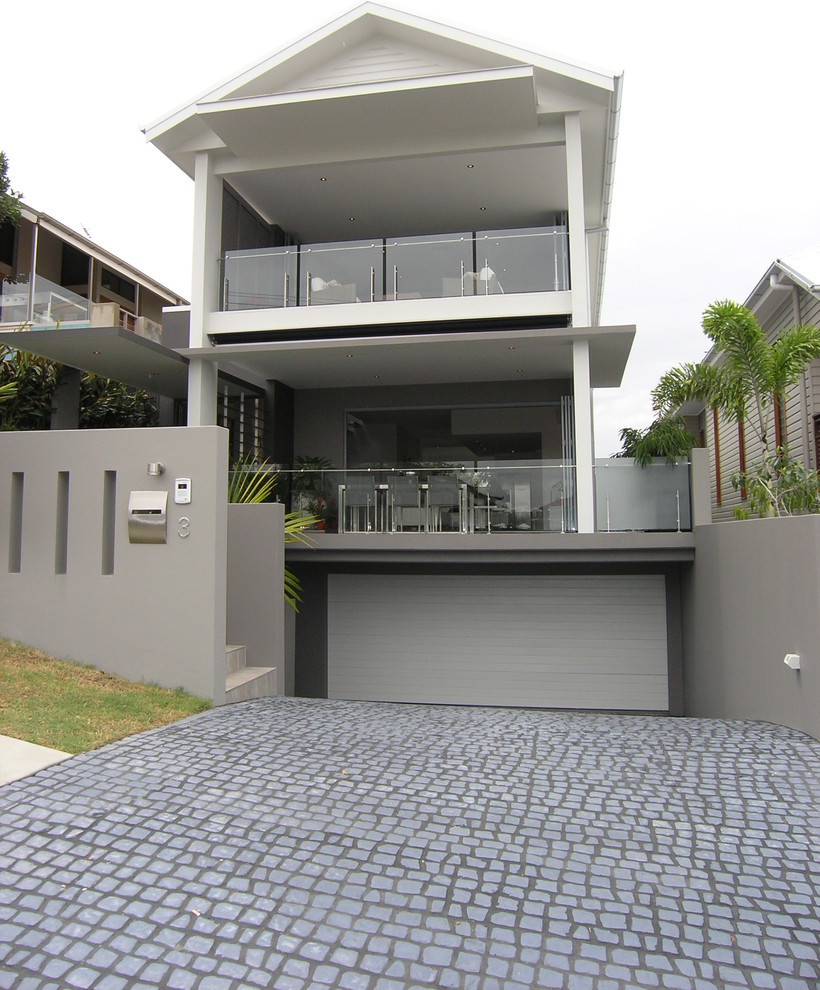 Inspiration for an expansive modern attached three-car garage in Brisbane.