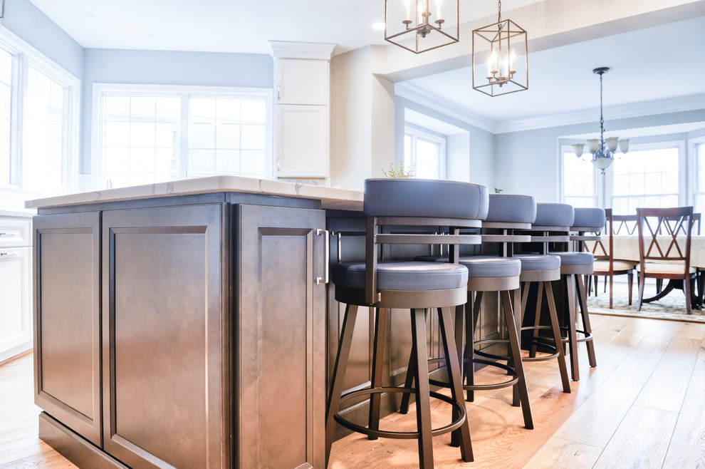 Inspiration for a huge transitional galley light wood floor and brown floor eat-in kitchen remodel in DC Metro with an undermount sink, beaded inset cabinets, white cabinets, quartzite countertops, white backsplash, marble backsplash, stainless steel appliances, an island and white countertops