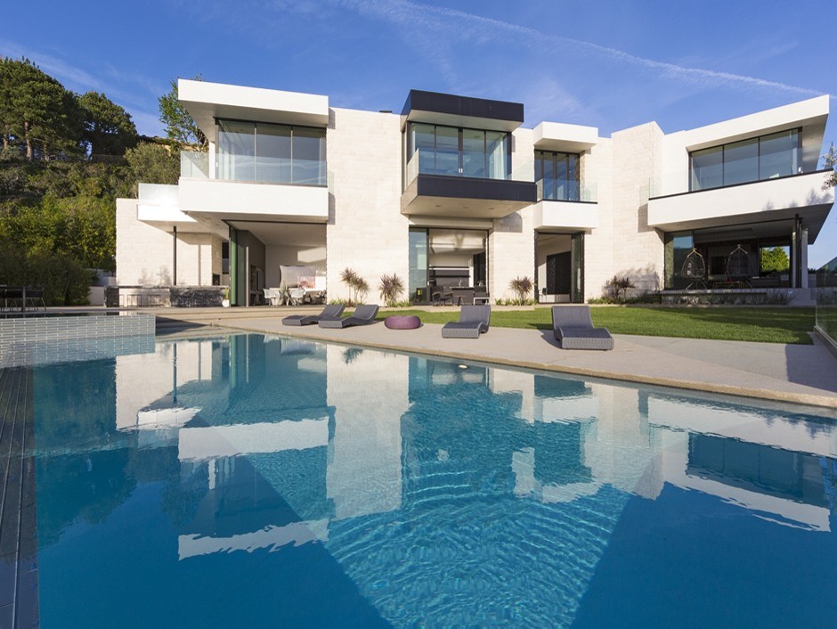Inspiration for a large modern backyard rectangular infinity pool in Los Angeles.