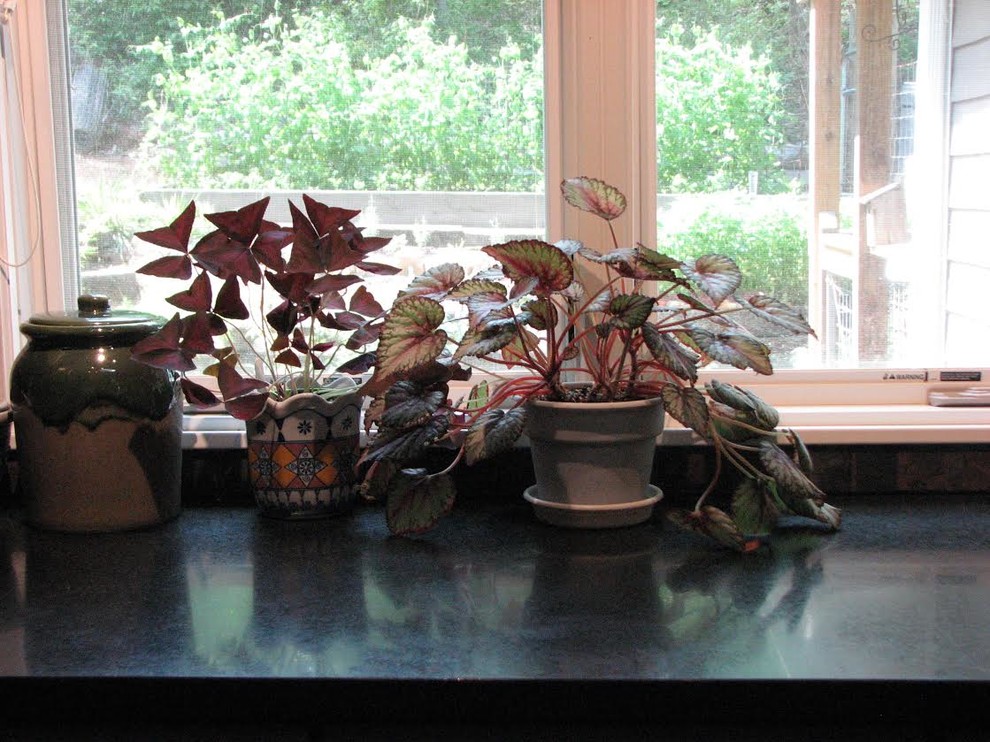 Example of a mid-sized transitional l-shaped porcelain tile kitchen design with an undermount sink, shaker cabinets, gray cabinets, granite countertops, brown backsplash, ceramic backsplash and stainless steel appliances