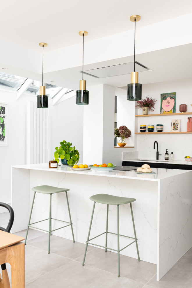 Large contemporary u-shaped eat-in kitchen in London with an integrated sink, flat-panel cabinets, black cabinets, solid surface benchtops, white splashback, marble splashback, panelled appliances, ceramic floors, with island, beige floor, white benchtop and coffered.