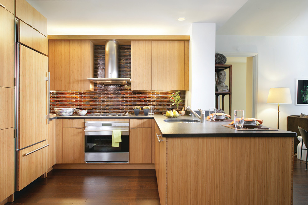 Contemporary u-shaped open plan kitchen in New York with an undermount sink, flat-panel cabinets, medium wood cabinets, brown splashback, stainless steel appliances, dark hardwood floors and a peninsula.