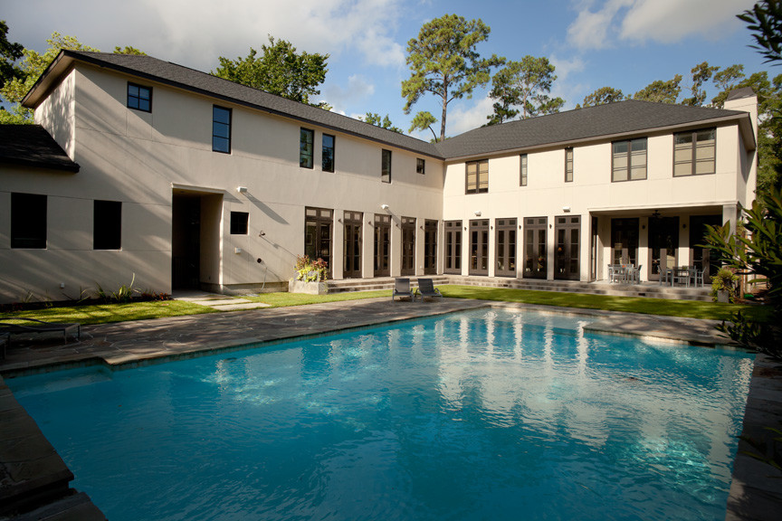 Inspiration for a mid-sized transitional backyard stone and rectangular pool remodel in Houston