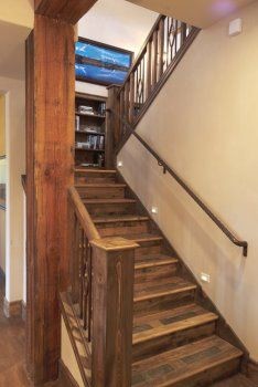 Staircase - mid-sized rustic wooden u-shaped wood railing staircase idea in Orange County with wooden risers