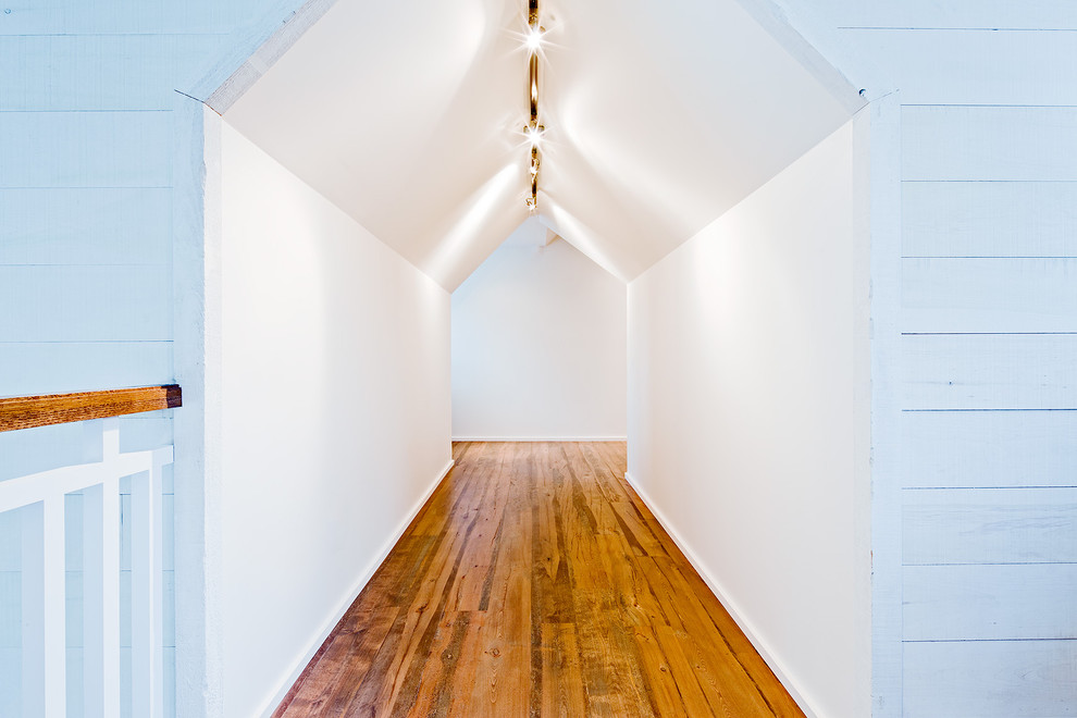 Design ideas for a country hallway in Toronto with white walls and medium hardwood floors.