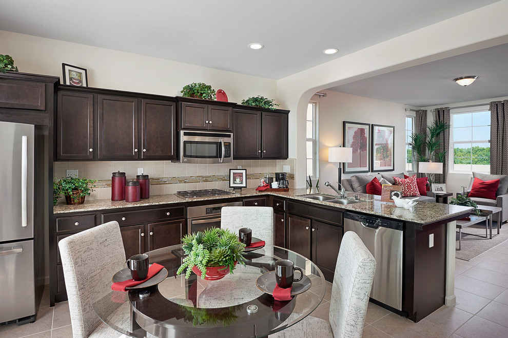 Inspiration for a transitional beige floor open concept kitchen remodel with dark wood cabinets, granite countertops and beige backsplash