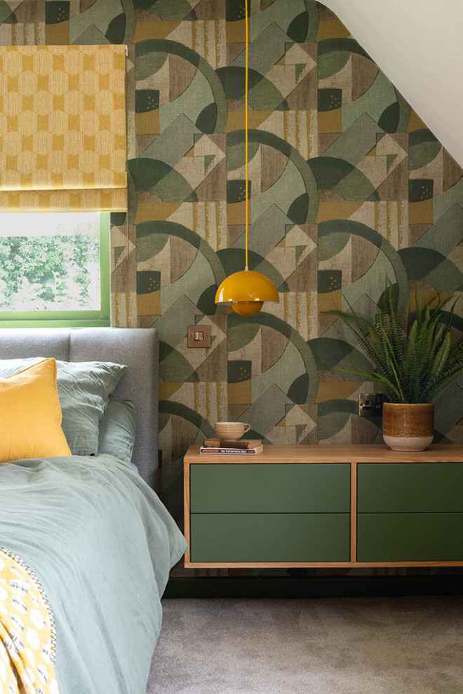 Photo of a mid-sized midcentury master bedroom in West Midlands with green walls, carpet, beige floor, vaulted and wallpaper.