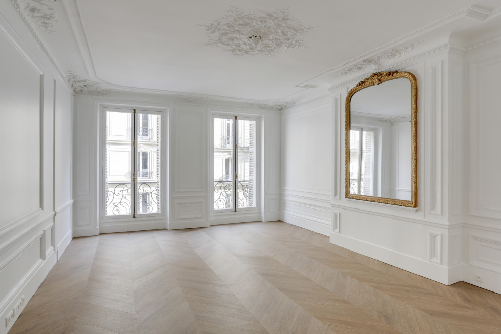 Expansive transitional enclosed living room in Paris with white walls, linoleum floors, no fireplace, beige floor and decorative wall panelling.