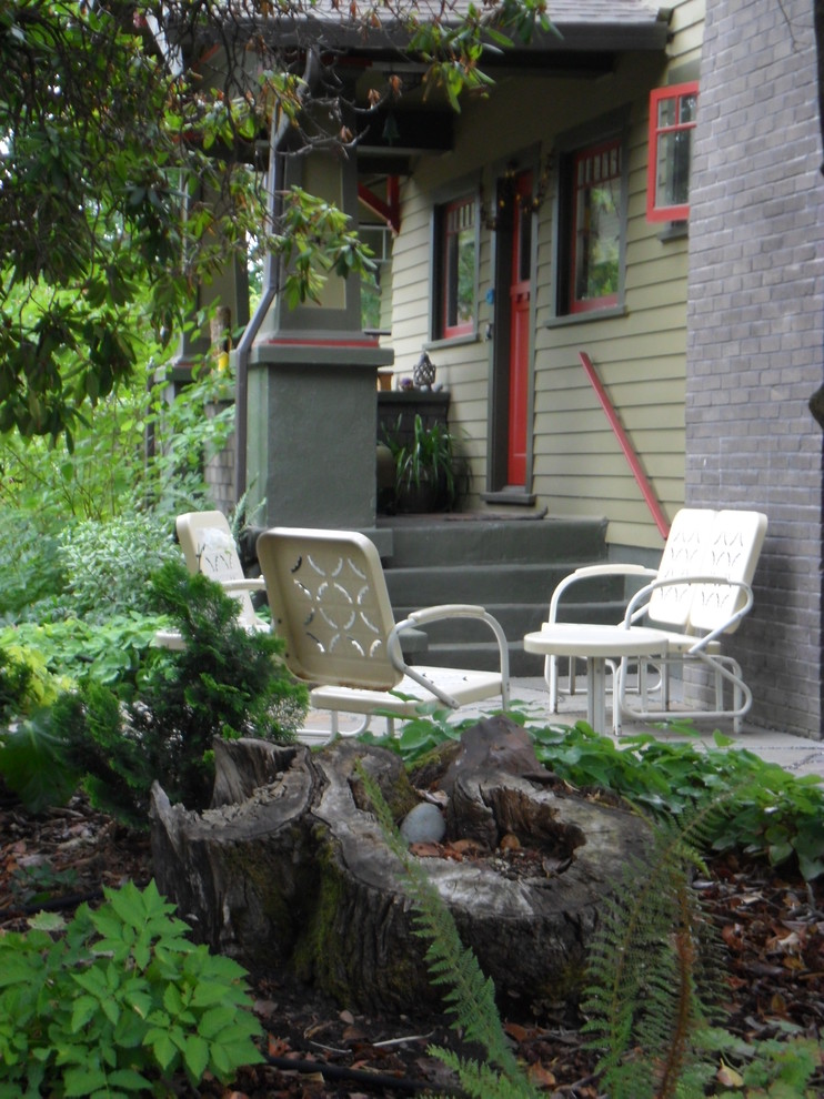 Photo of a small eclectic front yard full sun garden for summer in Portland with natural stone pavers.