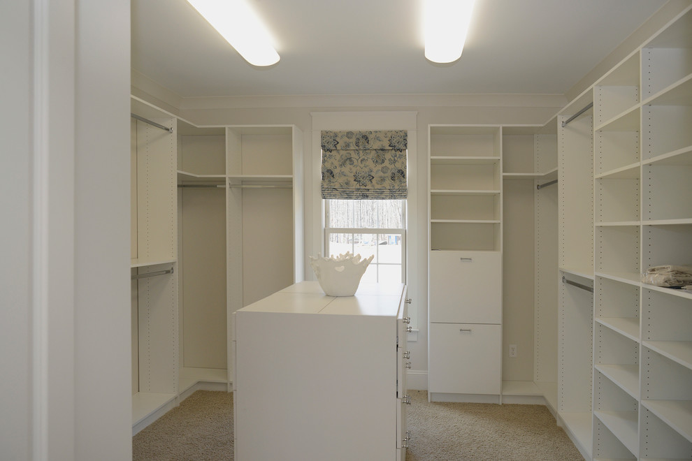 Inspiration for a large country walk-in wardrobe in Other with white cabinets and carpet.