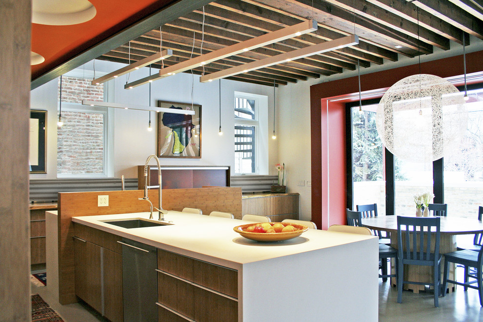 Contemporary eat-in kitchen in Chicago with an undermount sink, flat-panel cabinets and medium wood cabinets.