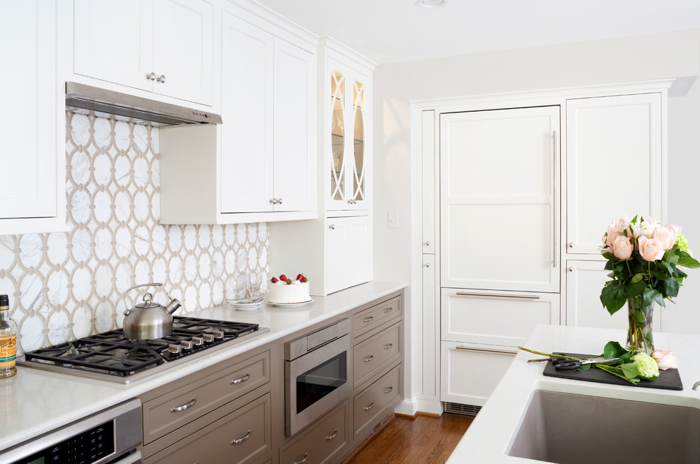 This is an example of a large traditional galley eat-in kitchen in DC Metro with a farmhouse sink, recessed-panel cabinets, grey cabinets, marble benchtops, white splashback, stone tile splashback, stainless steel appliances, medium hardwood floors and with island.