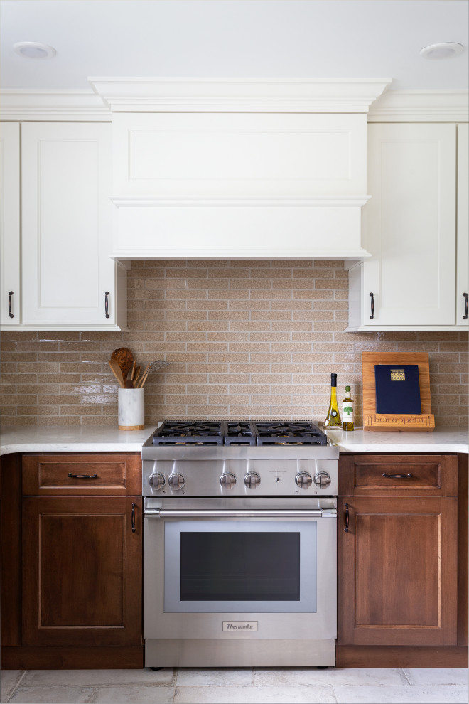 Transitional kitchen photo with shaker cabinets, medium tone wood cabinets, quartz countertops, beige backsplash, stainless steel appliances and white countertops