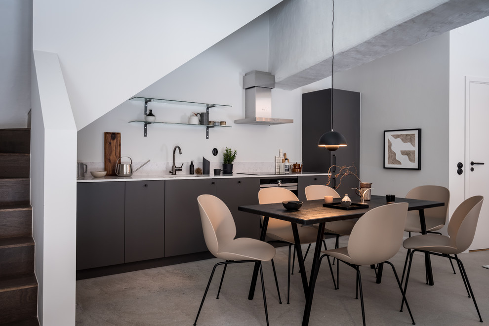 Inspiration for a mid-sized scandinavian kitchen/dining combo in Gothenburg with white walls, concrete floors and grey floor.