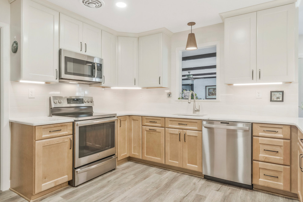 Kitchen pantry - huge transitional u-shaped kitchen pantry idea in DC Metro with an undermount sink, recessed-panel cabinets, quartz countertops, white backsplash, subway tile backsplash, stainless steel appliances, a peninsula and white countertops