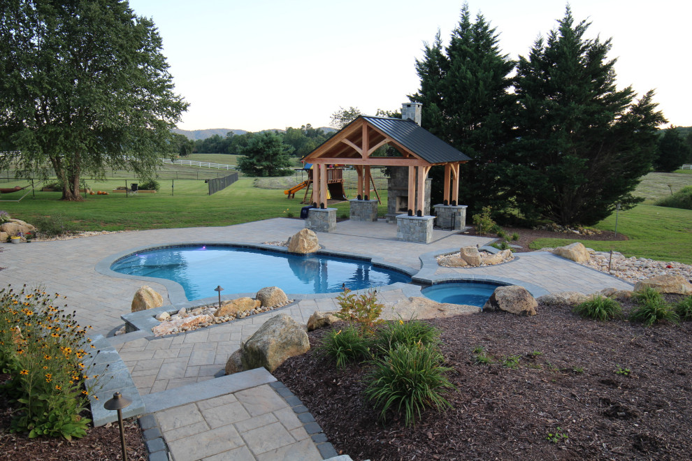 Inspiration for a mid-sized country backyard custom-shaped natural pool in DC Metro with with a pool and brick pavers.