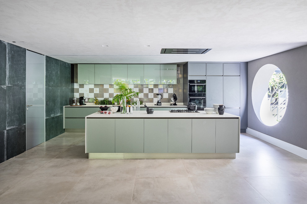 Inspiration for a modern galley kitchen in New York with flat-panel cabinets, grey cabinets, brown splashback, panelled appliances, with island, beige floor and white benchtop.