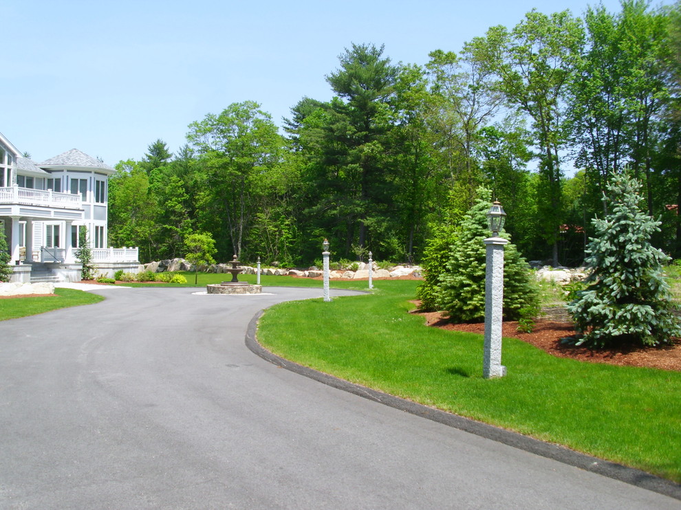 Photo of an expansive traditional front yard full sun driveway in Boston with a garden path.