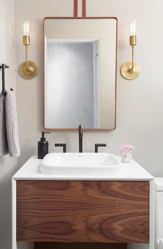 Inspiration for a small modern powder room in Chicago with a drop-in sink, flat-panel cabinets, medium wood cabinets, engineered quartz benchtops, a one-piece toilet and grey walls.