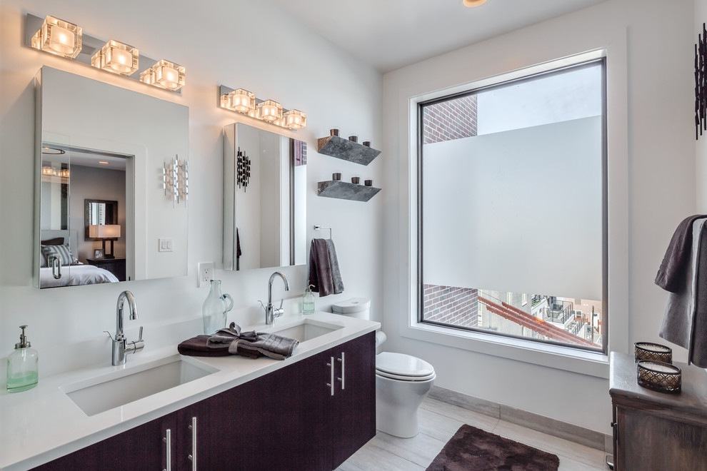 This is an example of a mid-sized contemporary master bathroom in Philadelphia with open cabinets, brown cabinets, an alcove shower, a one-piece toilet, gray tile, porcelain tile, white walls, porcelain floors, an undermount sink, engineered quartz benchtops, grey floor and a hinged shower door.